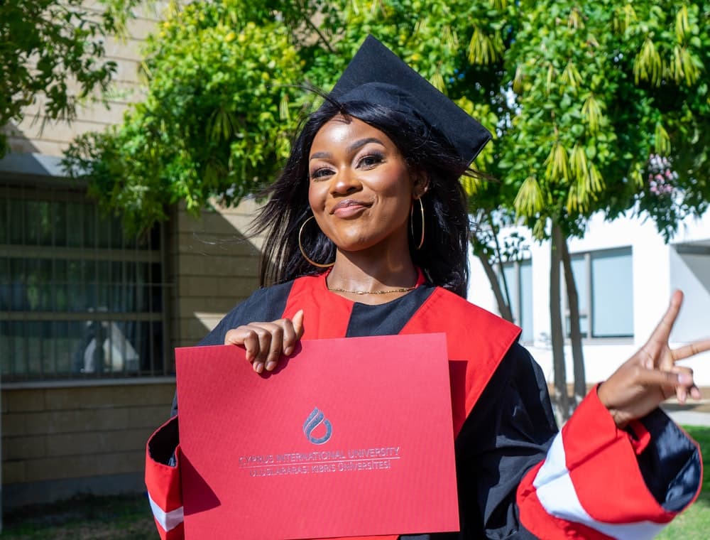 A graduate celebrating in cap and gown